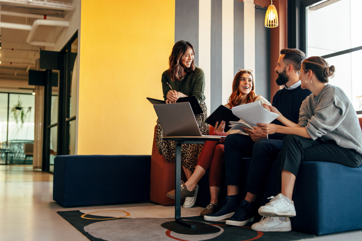 Group of business marketers sitting around a table talking about a website.