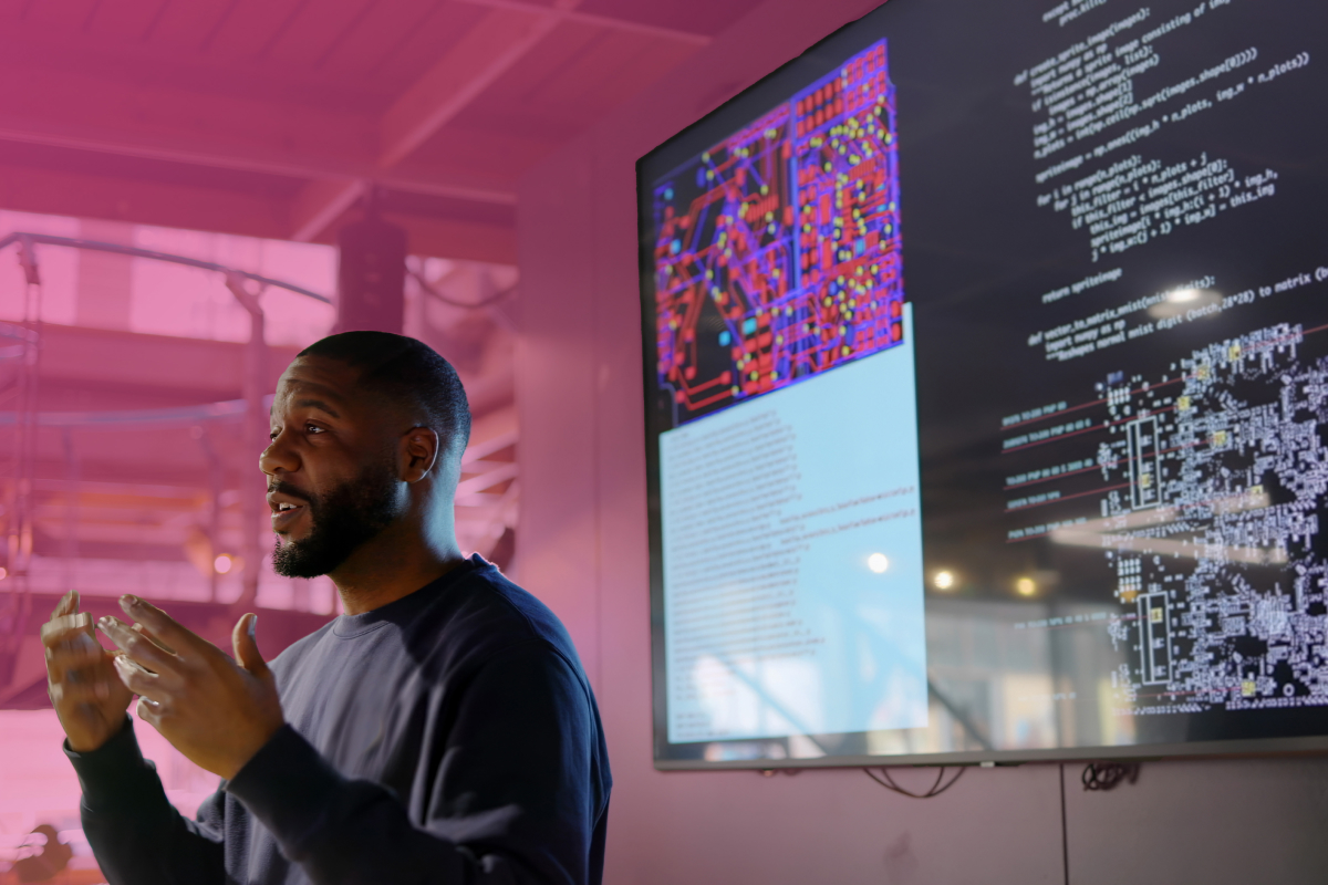 Hero image depicting a man in front of a data-rich dashboard giving a presentation.